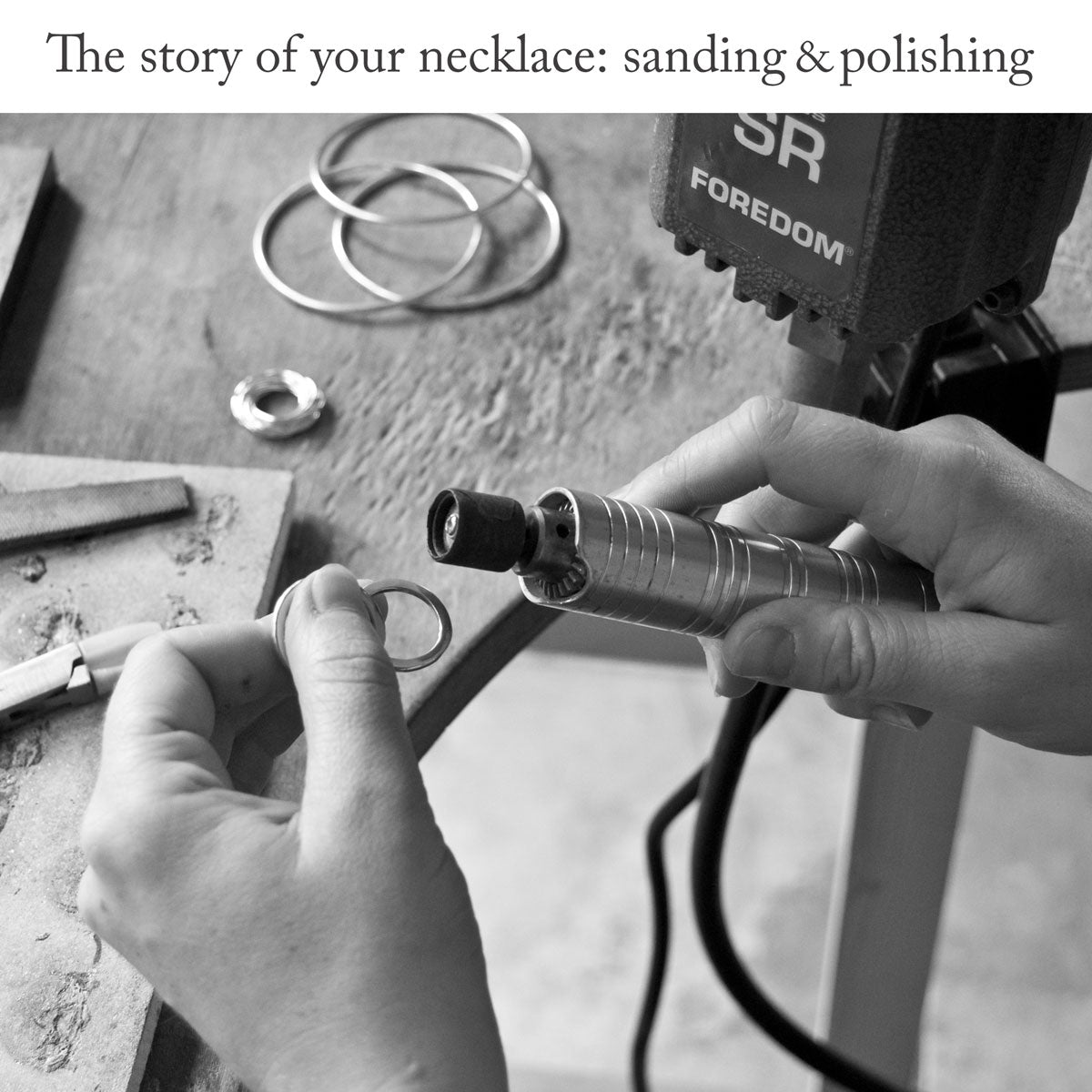 Jewellery maker sanding and polishing a ring with a Foredom tool over the surface of wooden work bench with the headline &#39;The story of your necklace: sanding and polishing&#39;