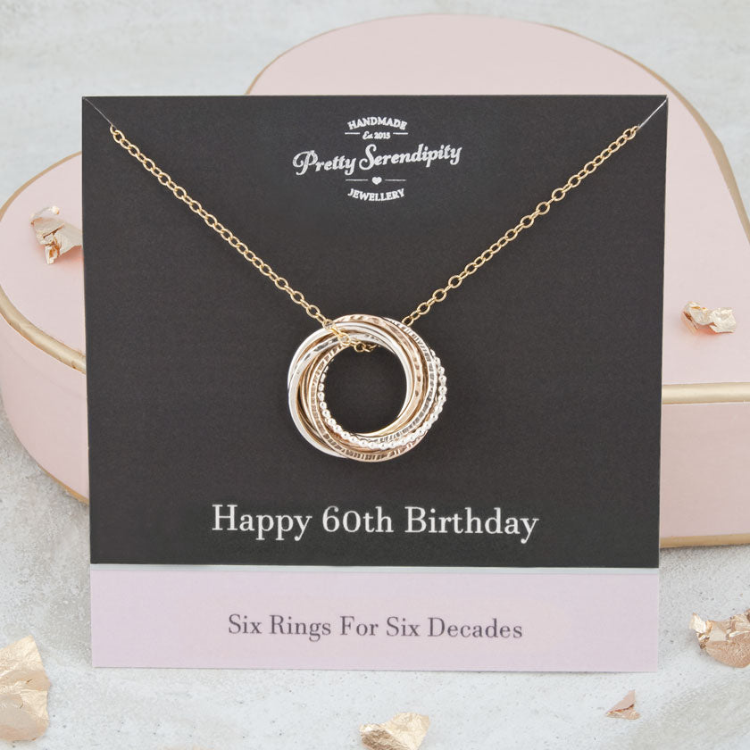 silver and gold 60th birthday necklace on black and pink gift card 